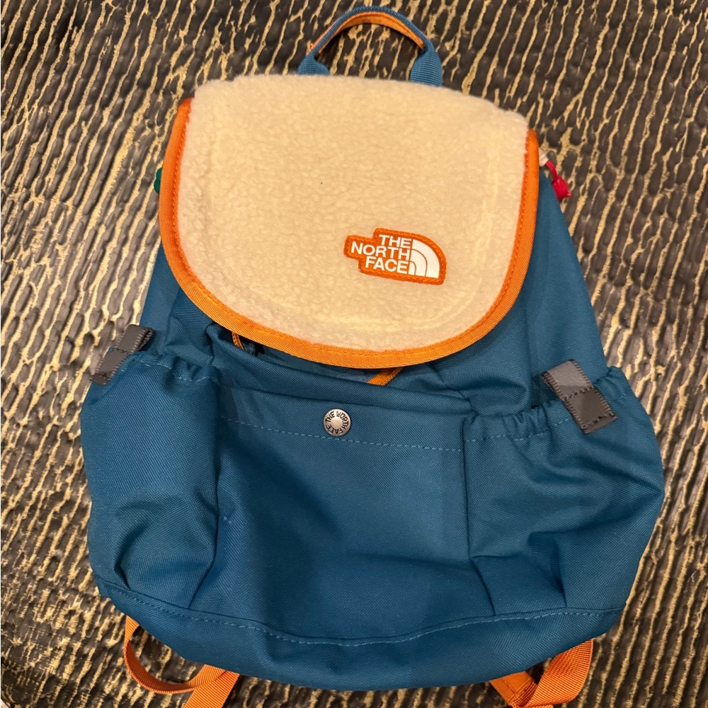 The North Face Blue and Orange Backpack with Classic Rucksack Design